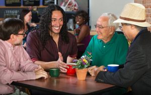 group of men in a cafe Photo by Scott Griessel Dreamstime. For article on learning a second language for all the wrong reasons. Image