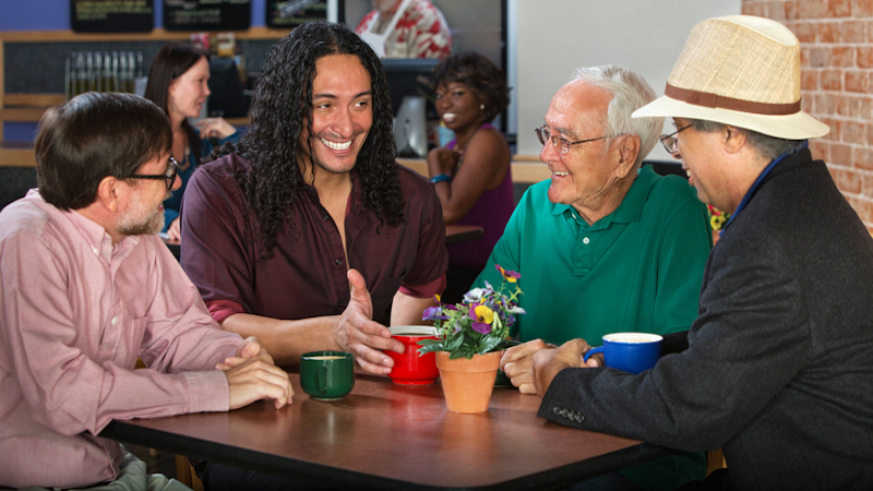 group of men in a cafe Photo by Scott Griessel Dreamstime. For article on learning a second language for all the wrong reasons.