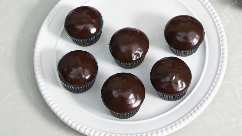 America’s Test Kitchen brings us their tested recipe for super-chocolaty cupcakes, made with cocoa powder and crowned with a delicious chocolate glaze. This is a great shareable dessert for chocolate lovers. Image