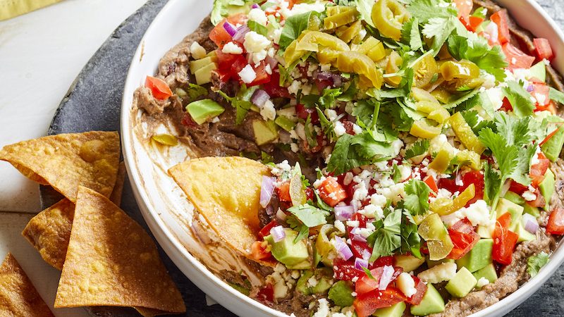 Loaded 7-layer black bean dip from EatingWell. This dip is easy to make and oh-so flavorful. Image