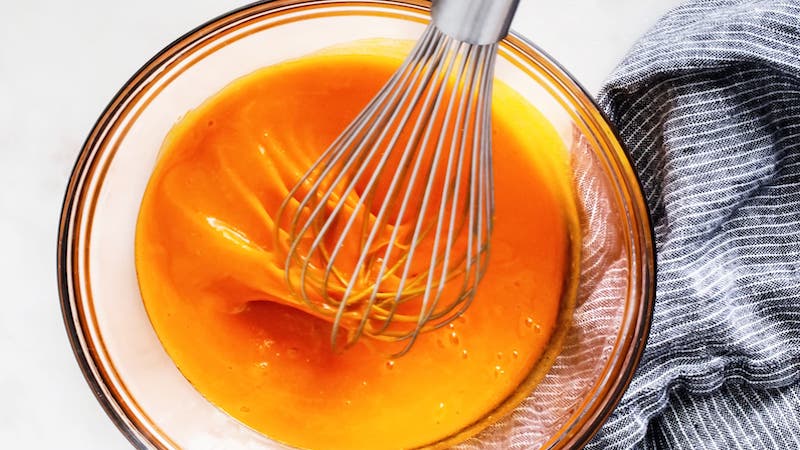 A whisk in a bowl of Buffalo sauce. From Entree, Tribune Content Agency, TheKitchn. You can make your own sauce in the comfort of your own home.