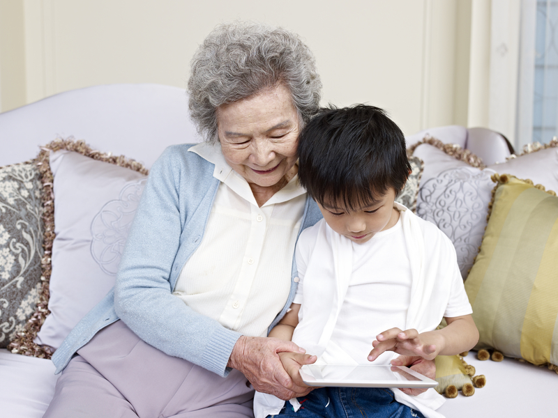 grandmom grandson on tablet puzzle Imtmphoto Dreamstime