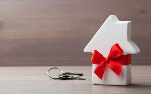house with bow Photo by Julia Sudnitskaya Dreamstime. Article on, Advice from Amy: Strings Attached to Selling House to Son Image