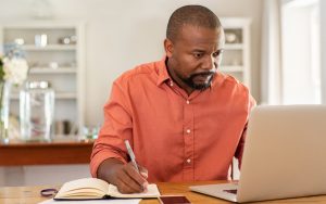 man on laptop maybe doing puzzle photo by Rido Dreamstime Image