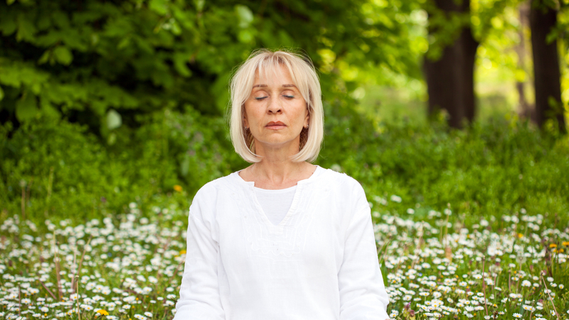 mindfulness and positivity: woman meditating outside Photo by Milovan Radmanovac Dreamstime.com