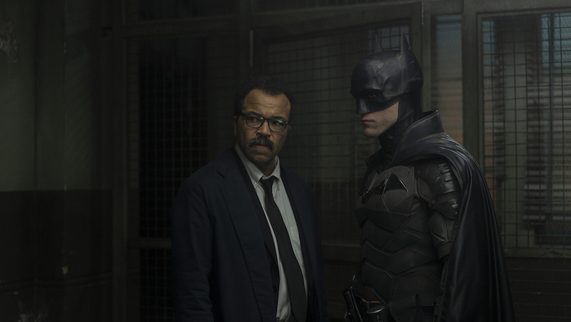 Jeffrey Wright (left) as Lt. James Gordon and Robert Pattinson in “The Batman." (Warner Bros. Pictures/TNS). "The Batman" goes darker than “The Dark Knight,” deadlier than “No Time to Die” and longer than “Dune” with a sullen, serious-minded antihero.