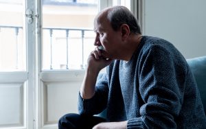 confused man sitting at home. photo by Samwordley Dreamstime. Columnist Robert Koehler shares a recent “breakthrough” moment, where geezerhood met the hard realities of life’s tragedies and unknowns. Image