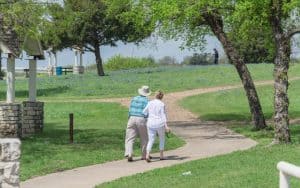 couple walking in a park Photo by Trong Nguyen Dreamstime. For article, These three happiness tips can help you rise above the tensions of the past couple of years. They're easy but can make a positive difference. Image