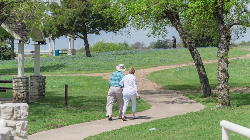 couple walking in a park Photo by Trong Nguyen Dreamstime. For article, These three happiness tips can help you rise above the tensions of the past couple of years. They're easy but can make a positive difference.