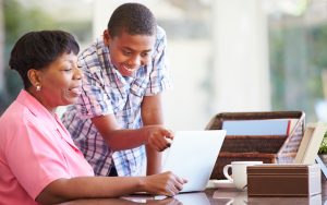 grandmother grandson looking at laptop, possibly doing a puzzle. Photo by Monkey Business Images Dreamstime. For Jumble joy Image