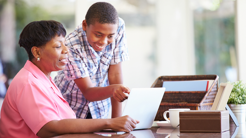 grandmother grandson looking at laptop, possibly doing a puzzle. Photo by Monkey Business Images Dreamstime. For Jumble joy