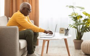 man on laptop photo by prostockstudio dreamstime. For Ask Amy column on a romance scam Image