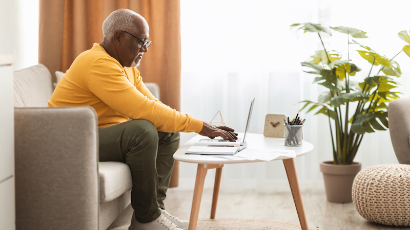 man on laptop photo by prostockstudio dreamstime. For Ask Amy column on a romance scam