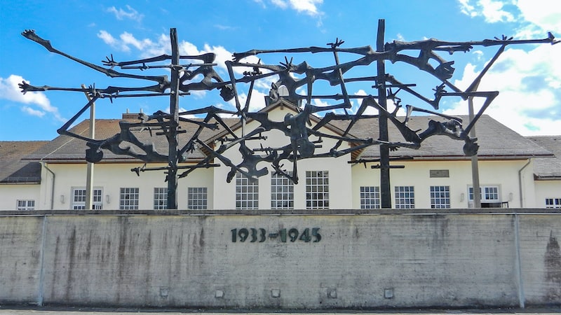 Image of the sculpture to remember the victims of Dachau. Travel writer Rick Steves takes us through the Dachau concentration camp, where visitors are reminded: “Forgive, but never forget.” Image
