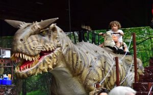 Picture from Jurassic Quest, with a child 