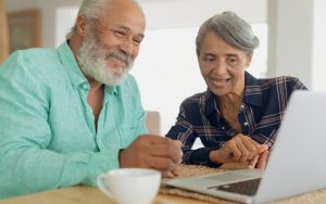 couple on laptop possibly doing a puzzle. image by Wavebreakmedia Dreamstime 800 Image