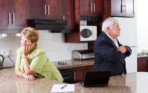 unhappy senior couple at home in kitchen, with their backs to each other. After 46 years, her good, solid, loving husband is leaving and she is blindsided by this sudden divorce. See what advice columnist Amy Dickinson says in this edition of “Ask Amy.” Image