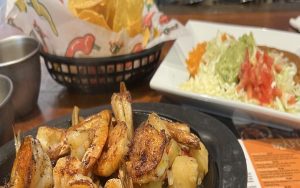 Shrimp, guacamole salad, rice, refried beans, and chips. Potros Mexican Restaurant in Richmond's West End serves delicious sizzling seafood plus traditional and nontraditional Mexican fare. Image