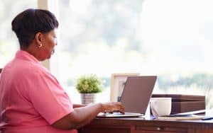 black woman on laptop doing puzzle photo by Monkey Business Images Dreamstime. For Boggle metal mania puzzle Image