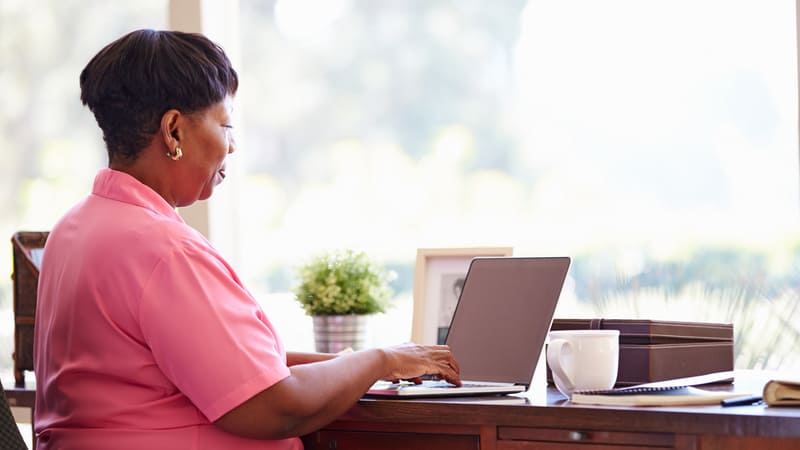 black woman on laptop doing puzzle photo by Monkey Business Images Dreamstime. For Boggle metal mania puzzle Image