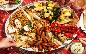 A delicious platter of grilled mixed vegetables, merguez sausage, halloumi cheese, and crispy chickpeas. Kelli Foster of TheKitchn.com shares her tips and ideas for creating a delicious, impressive mixed grill for your warm-weather gathering. Image