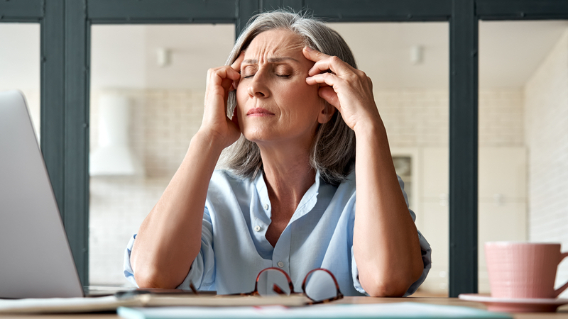 stressed woman at work photo by. Dark1elf Dreamstime. For article on fighting ageism in the workplace.