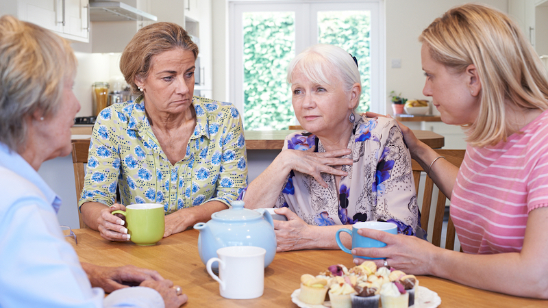 four female friends around a kitchen table consoling one unhappy friend. photo by Ian Allenden Dreamstime. Forged when kids were young, fading since: in the seasons of friendship, is it time to end this one-sided affair? See what “Ask Amy” says. 