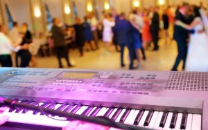 keyboard with a dance floor in the background, including a bride and groom dancing, wedding reception band photo by wideonet Dreamstime. Whether planning your wedding reception or hosting the event for a son or daughter, this wedding reception band checklist and tips can help. Image