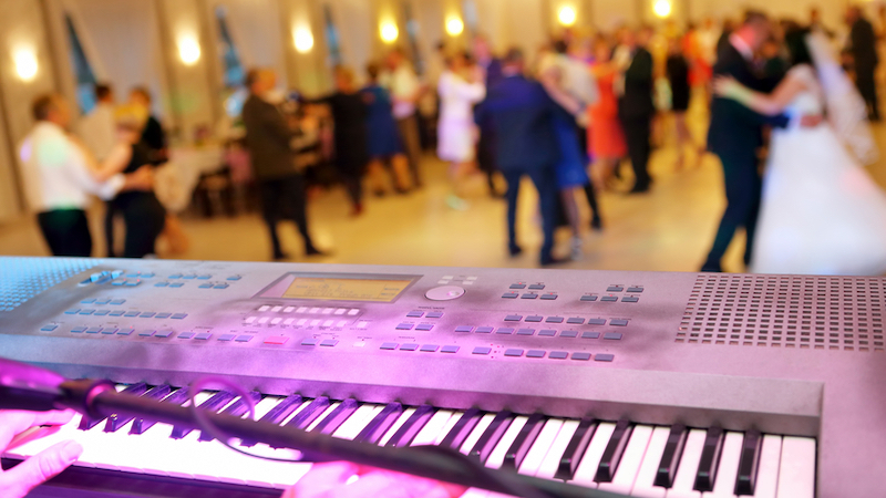 keyboard with a dance floor in the background, including a bride and groom dancing, wedding reception band photo by wideonet Dreamstime. Whether planning your wedding reception or hosting the event for a son or daughter, this wedding reception band checklist and tips can help.