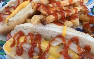 hot dogs, cheese, onions, and ketchup with fries. Food writer Steve Cook shares a tiny spot that serves some of the best grilled burgers and hot dogs in Richmond, Pop's Dogs & Ma's Burgers. Image