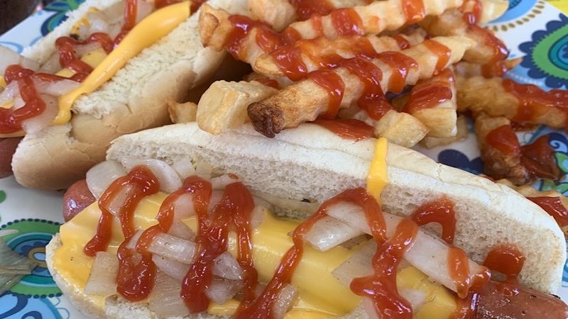 hot dogs, cheese, onions, and ketchup with fries. Food writer Steve Cook shares a tiny spot that serves some of the best grilled burgers and hot dogs in Richmond, Pop's Dogs & Ma's Burgers. Image