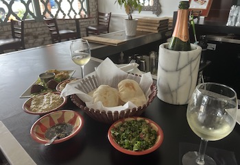 Mezze platter with cava sparkling wine at Natalie’s Taste of Lebanon, where the mission, to advocate for and employ people with disabilities, is just as good as the Mediterranean food.