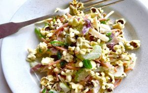Popcorn salad stars at Midwest picnics and barbecues, a surprisingly delicious retro side dish with a satisfying crunch. Image