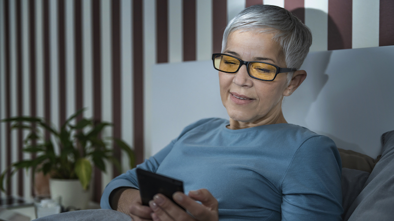 woman wearing blue light blocking photo by Microgen Dreamstime. Blue light-blocking glasses have been shown to spare our eyes from issues with the light from computers. Can they improve our sleep, too? 