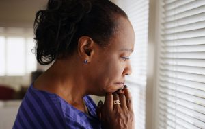 worried woman at her kitchen window. photo by Mark Adams Dreamstime. A mom suspects her grown daughter has an eating disorder. Should she intervene in her adult daughter’s problems? See what “Ask Amy” says. Image