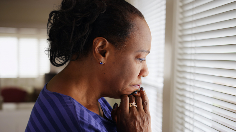 worried woman at her kitchen window. photo by Mark Adams Dreamstime. A mom suspects her grown daughter has an eating disorder. Should she intervene in her adult daughter’s problems? See what “Ask Amy” says.