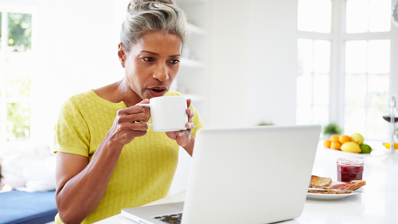 Woman on laptop, possibly doing a Boggle or Jumble or other puzzle. Photo by Monkey Business Images, Dreamstime