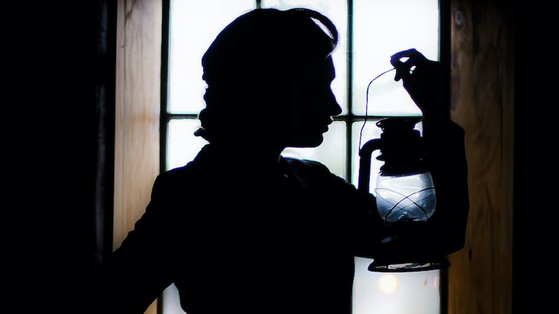 Promotional image of a woman's silhouette, holding a gas lantern. "Gaslight" plays at Swift Creek Mill Theatre, South Chesterfield, from Sept.9 to Oct. 15. Also used for the 'Gaslight' contest.