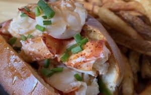 Lobster roll with fries on the side. Food and travel writer Steve Cook stumbles upon an unexpected find near the Blue Ridge Mountains in Virginia: a restaurant teeming with seafood, Public Fish & Oyster in Charlottesville. Image