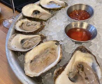 platter of raw oysters with cocktail sauce. Food and travel writer Steve Cook stumbles upon an unexpected find near the Blue Ridge Mountains in Virginia: a restaurant teeming with seafood, Public Fish & Oyster in Charlottesville.