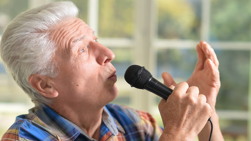 man singing karaoke Ruslan Huzau Dreamstime, for article on misheard lyrics - misheard song lyrics. Greg Schwem likes to sing along to songs, but he admits to botching the lyrics, turning a classic rock song into a puzzling reprised version.