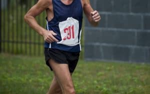 an older man running in a race. For article on the tall lithe brunette that passed the man, then lost to him at the end. Image