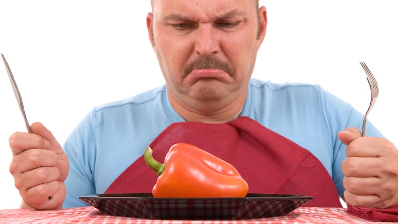 unhappy dieter with a pepper on his plate - photo by Simone Van Den Berg, Dreamstime. Is it okay to cheat on a diet? Or should I follow my weight-loss diet strictly and carefully and always avoid “cheat meals”?