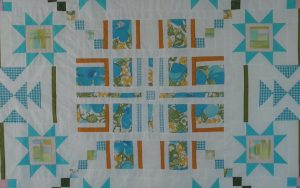 A quilt made from pieces of her mother's aprons: Author, educator, and Boomer reader Diann Logan recalls her mother’s many aprons over the years, her childhood game of playfully untying her mother’s apron strings, the fabrics that made these homespun garments, and the aprons as her ties to the past. Image