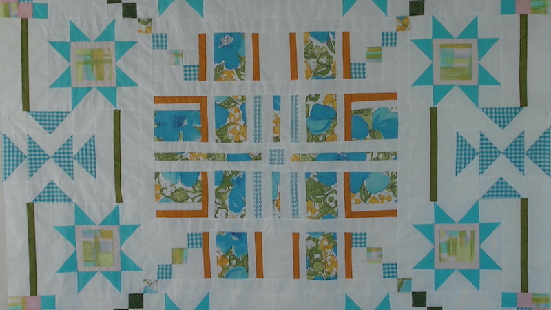A quilt made from pieces of her mother's aprons: Author, educator, and Boomer reader Diann Logan recalls her mother’s many aprons over the years, her childhood game of playfully untying her mother’s apron strings, the fabrics that made these homespun garments, and the aprons as her ties to the past. Image