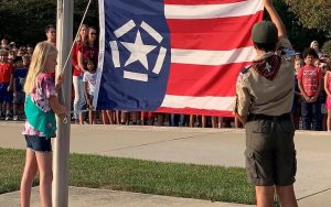 Schoolchildren raise the Freedom Flag at their school. In the wake of 9/11, a restaurateur in Richmond, Virginia, created the Freedom Flag to symbolize the import of the day and to honor the importance of freedom into the future. Image