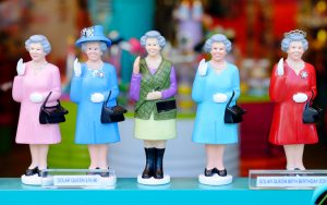 Queen dolls in a shop window. Photo by Nuii7711, Dreamstime. Writer and humorist Nick Thomas probes the royal humor of Queen Elizabeth II, her husband, and her successor and speculates on other lost opportunities at regal fun. Image