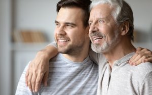 Father and adult son. Image by Fizkes, Dreamstime. Through DNA testing, Dad discovers his son is not his biological son. Mom refuses to discuss, even with the son. See what “Ask Amy” advises. Image
