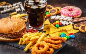 lots of junk foods, like cola, fries, onion rings, donut, candy, and more. Photo by Nina Firsova, Dreamstime. When two longtime friends were vacationing together, one got angry that the other wasn't snacking with her. Is there a snacking etiquette? Image