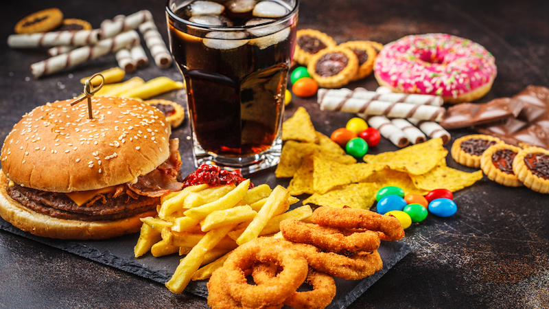 lots of junk foods, like cola, fries, onion rings, donut, candy, and more. Photo by Nina Firsova, Dreamstime. When two longtime friends were vacationing together, one got angry that the other wasn't snacking with her. Is there a snacking etiquette? Image